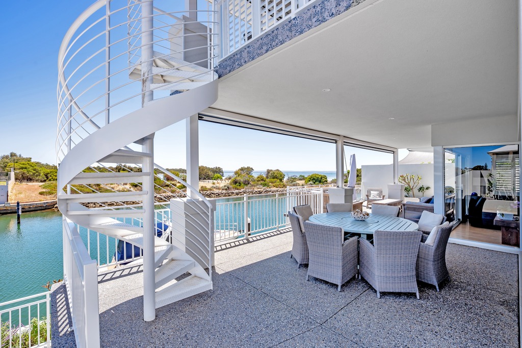 Wannanup canal home exterior with modern architecture and outdoor seating area